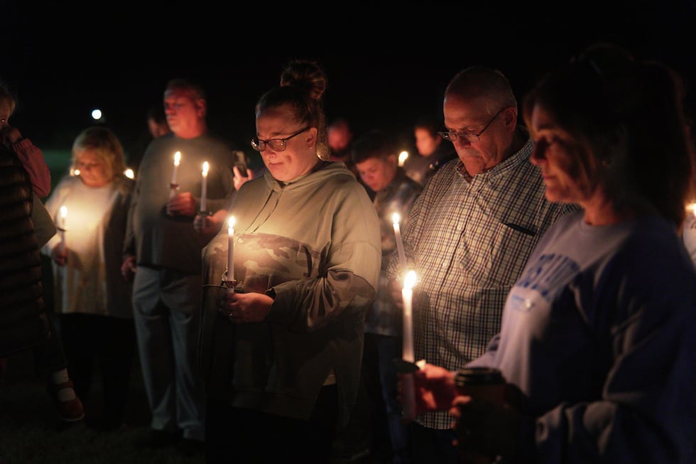 Residents attend a vigil honoring the victims of a blast at an explosives plant, Accurate...