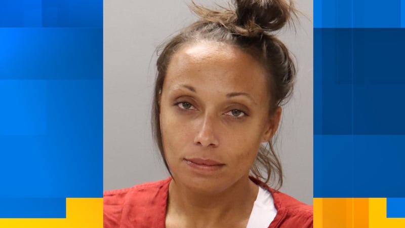 Woman facing multiple charges after being found passed out in car with an infant.