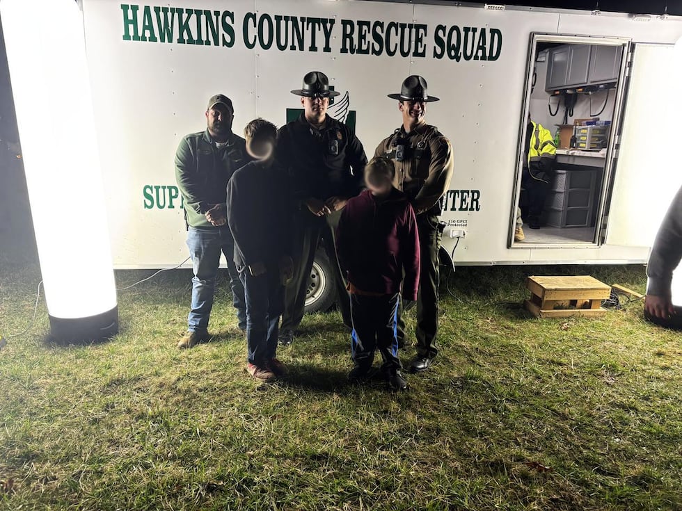 Tennessee State Troopers and Hancock County Rescuers are pictured with two boys, ages 10 and...
