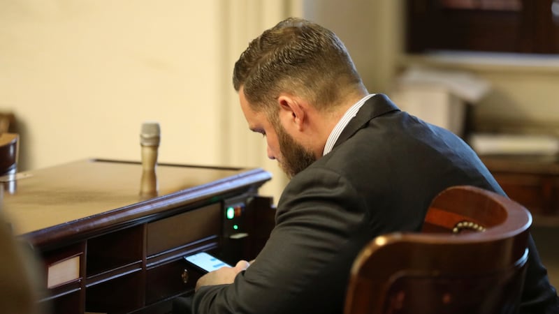 FILE - Republican South Carolina Rep. R.J. May of Lexington sits at his new desk during the...
