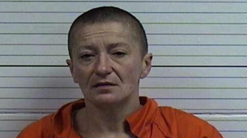 A woman was arrested after she was found with an envelope carrying $14,000 in cash.